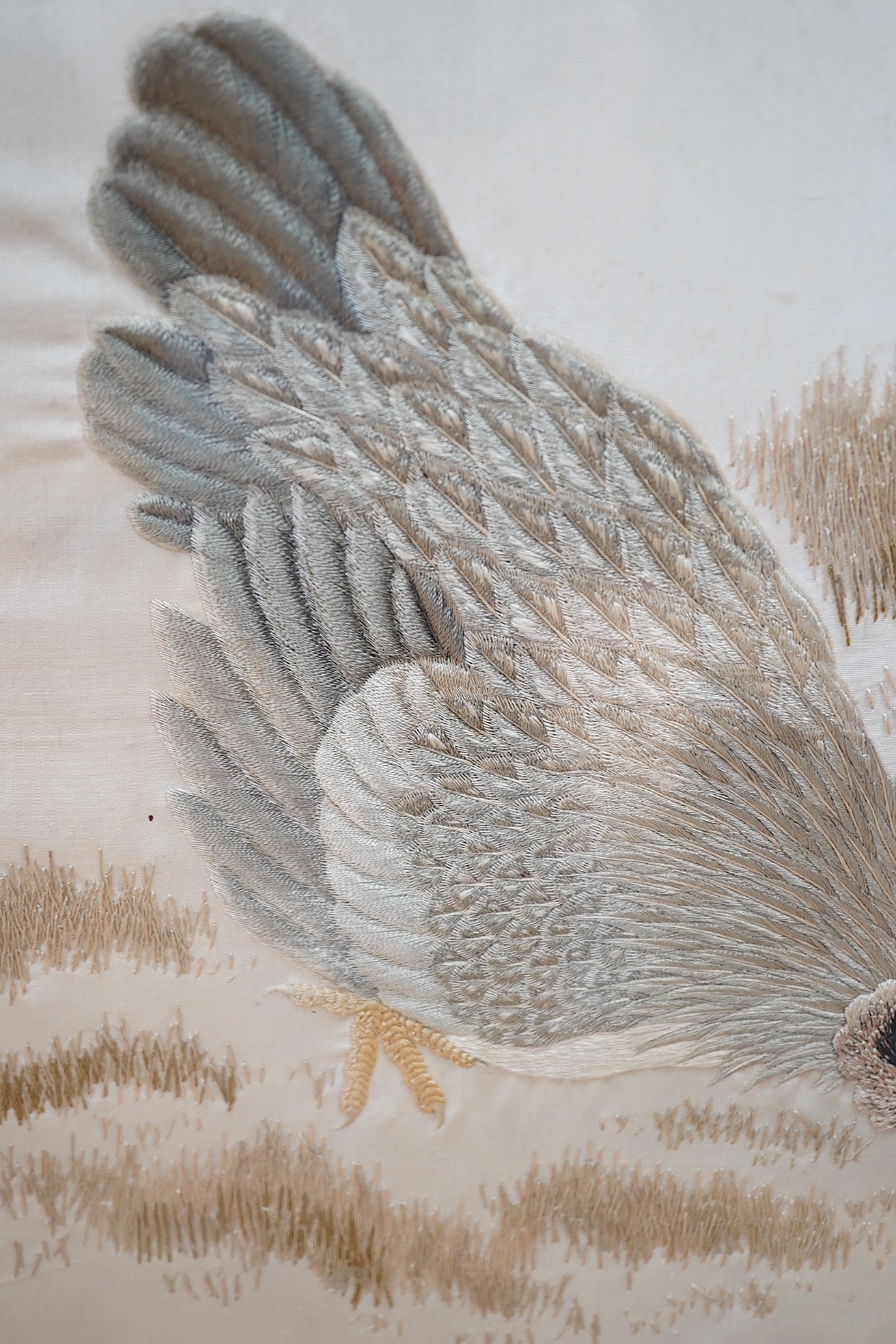 A Victorian fire screen inset with a Japanese cream silk embroidered panel of a cockerel, hen and two chicks, beautifully embroidered with rows of couched silk on the bodies of all the birds, their feathers and faces inc